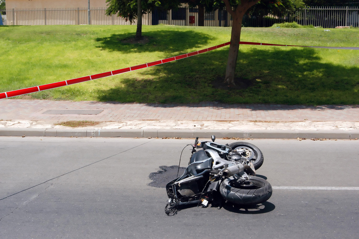 A Motorbike accident on a road is taped off by police